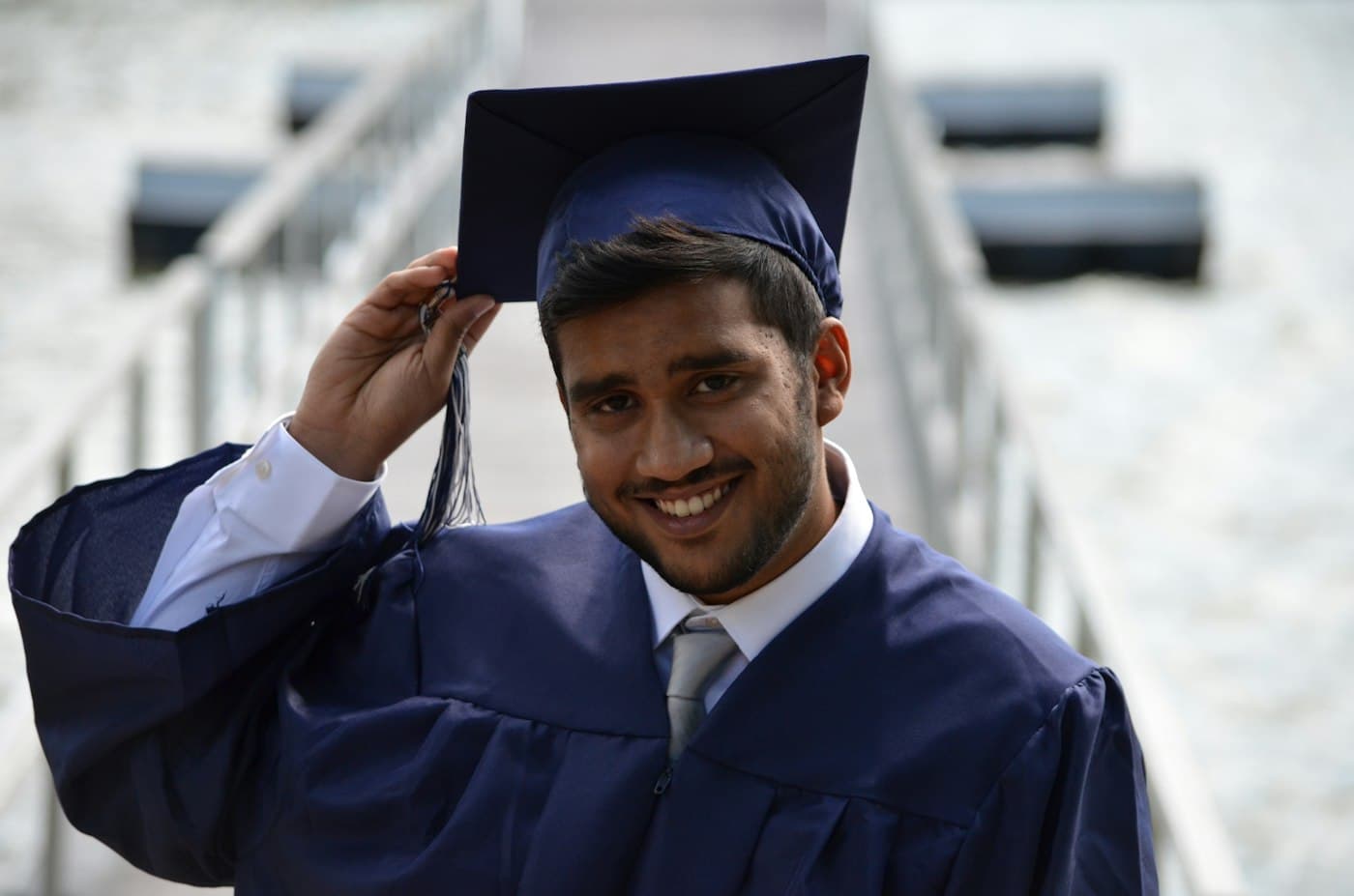 A smiling graduate in a cap and gown